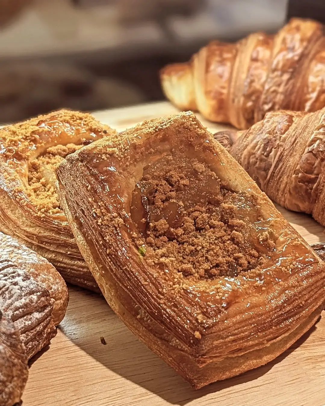 Pastries on a wooden board at CoffeeIsh, a danish and croissants.