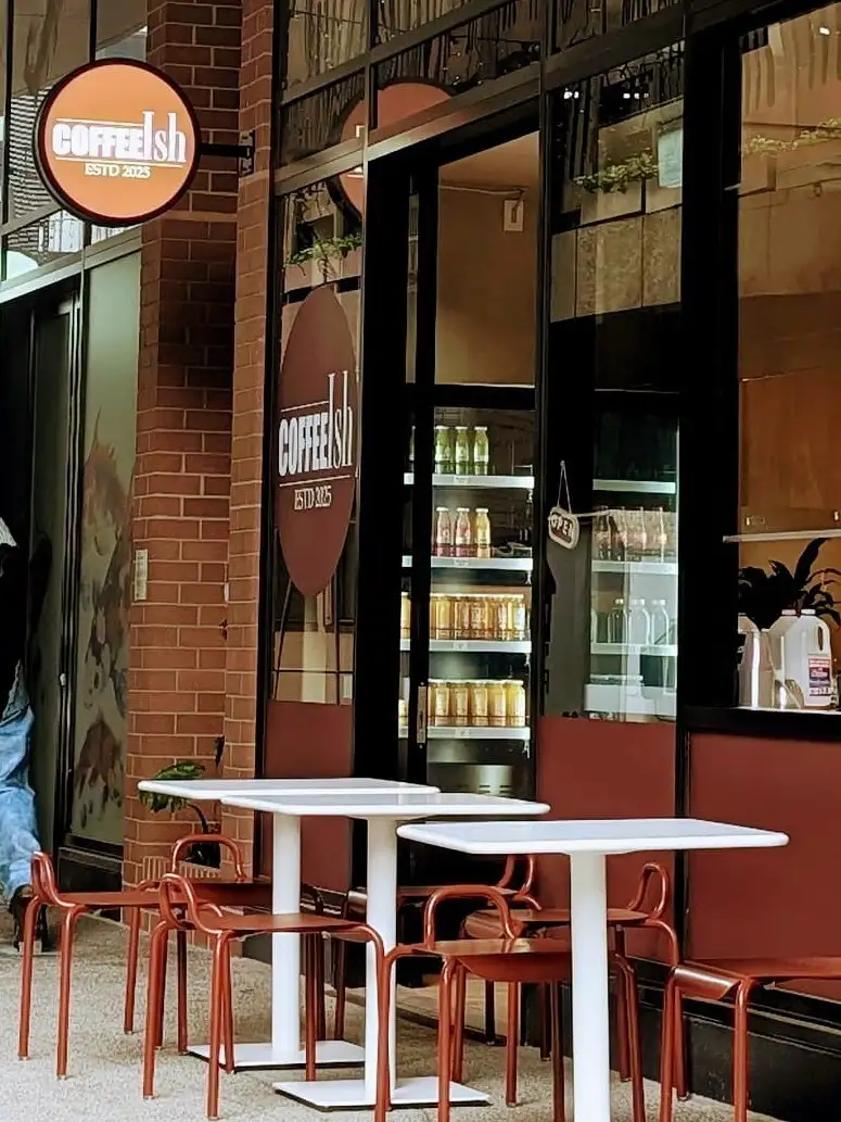 The CoffeeIsh shopfront on Fish Lane, tables and terracotta chairs on the footpath.